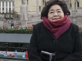 Hiroshima and an supporter of the International Campaign to Abolish Nuclear Weapons (ICAN), Setsuko Thurlow sits on a bench in front of the Norwegian parliament surrounded by 1000 paper cranes in Oslo, Saturday, Dec. 9, 2017. Thurlow was chosen to represent ICAN in accepting the Nobel Peace Prize on Sunday.