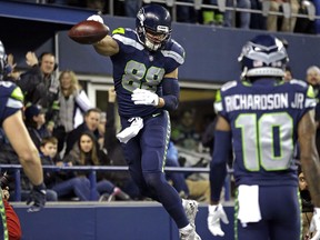 Seattle Seahawks' Jimmy Graham leaps to spike the ball after scoring a touchdown on an 11-yard pass reception against the Philadelphia Eagles during the first half of an NFL football game, Sunday, Dec. 3, 2017, in Seattle.