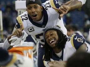 Los Angeles Rams cornerback Trumaine Johnson (22) and running back Todd Gurley, right, celebrate on the bench in the second half of an NFL football game against the Seattle Seahawks, Sunday, Dec. 17, 2017, in Seattle.