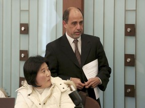 Tomas Ojea Quintana, right, the United Nations special rapporteur on the situation of human rights in North Korea, passes by North Korean defector Kim Ryen Hui as he arrives to hold a press conference in Seoul, South Korea, Thursday, Dec. 14, 2017. Quintana said Thursday that he requested the South Korean government to set up a meeting with the women who had worked at a North Korean-run restaurant in China before coming to the South in April last year.