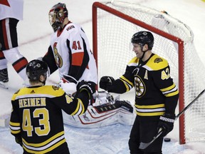 Boston Bruins right wing David Backes, right, is congratulated by Danton Heinen after his goal off Ottawa Senators goalie Craig Anderson during the third period in Boston, Wednesday. The Bruins defeated the Senators 5-1.