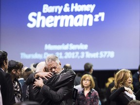 People console each other at a memorial service for Apotex billionaire couple Barry and Honey Sherman in Mississauga, Ontario on Thursday, December 21, 2017.
