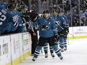 San Jose Sharks' Logan Couture, center, celebrates with teammates after scoring a goal against the Ottawa Senators during the first period of an NHL hockey game Saturday, Dec. 9, 2017, in San Jose, Calif.