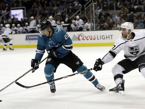 San Jose Sharks right wing Joonas Donskoi, left, is defended by Los Angeles Kings defenseman Alec Martinez during the first period of an NHL hockey game Saturday, Dec. 23, 2017, in San Jose, Calif.