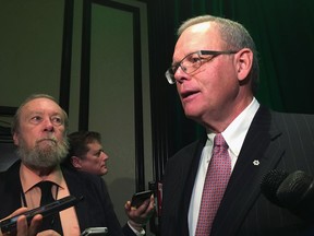 Sanford Riley, board chair at Manitoba Hydro, speaks to reporters after a speech to business leaders in Winnipeg on Friday, Dec. 1, 2017. Riley is hoping the Manitoba government will use some of the money collected through its proposed carbon tax to offset rising hydro rates for low-income earners. THE CANADIAN PRESS/Steve Lambert
