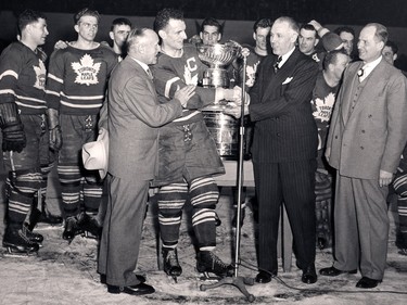 Ted Kennedy (centre) accepts the Stanley Cup from NHL president Clarence Campbell on April 16, 1949.