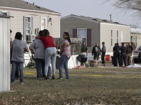 Residents of Pecan Grove Trailer Park  in Schertz, Texas, gather to watch Bexar County deputies investigate the scene of a shooting where officers killed a 30 year old female suspect on Thursday, Dec. 21, 2017.