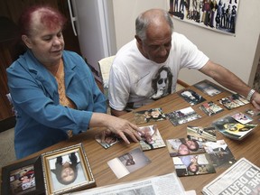 FILE - In this Aug. 15, 2016, file photo, Gordon Davis and his wife Thelma look through photos of their daughter, Lynette Daley, at their home in Yamba, Australia. A judge sentenced a man on Friday, Dec. 8, 2017 to at least 14 years in prison for the slaying of Lynette Daley who bled to death from a violent sexual assault on a remote beach. The sentence for the death of the Aboriginal woman in 2011 ends a years-long legal battle by her family in a case that exposed Australia's deep racial divide.
