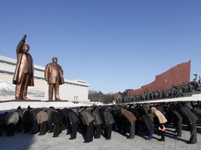 People bow to the bronze statues of their late leaders Kim Il Sung and Kim Jong Il at Mansu Hill, marking the sixth anniversary of leader Kim Jong Il's death in Pyongyang, Sunday, Dec. 17, 2017.