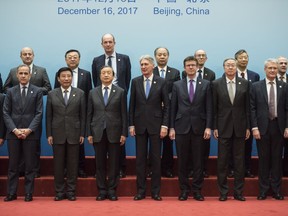 Britain's Chancellor of the Exchequer Philip Hammond, center right, and Chinese Vice Premier Ma Kai, center left, pose with delegates during the UK-China Economic Financial Dialogue at the Diaoyutai State Guesthouse in Beijing Saturday, Dec. 16, 2017.