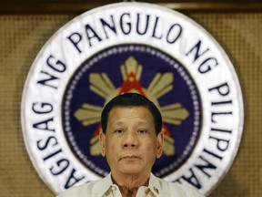 FILE - In this July 18, 2017 file photo, Philippine President Rodrigo Duterte stands in front of the presidential seal during a ceremony with the Armed Forces of the Philippines at the Malacanang presidential palace in Manila, Philippines. The Philippine Congress voted overwhelmingly Wednesday, Dec. 13, 2017,  to approve President Duterte's request to extend martial law in the south by a year after the military warned that terrorist threats continue to lurk despite the defeat of a disastrous pro-Islamic State group siege.