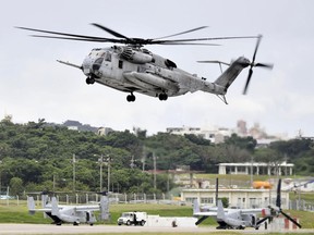 This Oct. 2017 photo shows U.S. Forces' CH53E helicopter in Ginowan, Okinawa.  A metal window frame has fallen from a U.S. military aircraft in flight and landed on a school playground on Okinawa, leaving a boy with minor injury from small gravels stirred up from the ground and escalating anti-American base sentiment on the southern island.