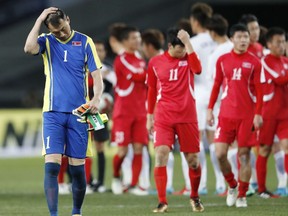North Korea's goalkeeper Ri Myong Guk, left, and teammates react after their loss to South Korea in their soccer match of the East Asian Championship in Tokyo, Tuesday, Dec. 12, 2017.