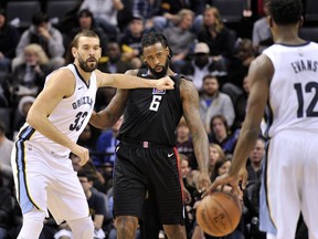 Memphis Grizzlies center Marc Gasol (33) moves for position against Los Angeles Clippers center DeAndre Jordan (6) as Grizzlies guard Tyreke Evans (12) moves the ball down court in the first half of an NBA basketball game Saturday, Dec. 23, 2017, in Memphis, Tenn.