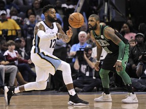 Memphis Grizzlies guard Tyreke Evans (12) passes the ball against Boston Celtics guard Kyrie Irving (11) in the first half of an NBA basketball game Saturday, Dec. 16, 2017, in Memphis, Tenn.