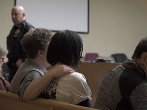 Zenobia Dobson is comforted by friends as she watches the jury enter the courtroom where they convicted Christopher Bassett of first degree murder of her son Zaevion Dobson death in Knoxville, Tenn., Thursday, Dec. 14, 2017.