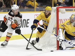 Anaheim Ducks right wing Ondrej Kase (25), of the Czech Republic, shoots against Nashville Predators goalie Pekka Rinne (35), of Finland, as Predators' Anthony Bitetto (2) defends in the first period of an NHL hockey game Saturday, Dec. 2, 2017, in Nashville, Tenn.