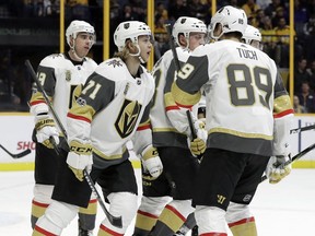 Vegas Golden Knights center William Karlsson (71), of Sweden, celebrates with teammates after scoring a goal against the Nashville Predators during the first period of an NHL hockey game Friday, Dec. 8, 2017, in Nashville, Tenn.