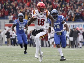 Iowa State wide receiver Hakeem Butler (18) runs away from Memphis defenders Tim Hart (35) and Jonathan Cook (14) as Butler runs for a touchdown on a 52-yard pass play in the first half of the Liberty Bowl NCAA college football game, Saturday, Dec. 30, 2017, in Memphis, Tenn.