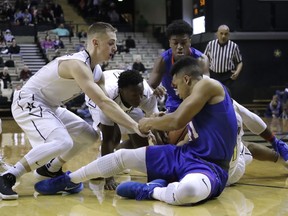 Vanderbilt guard Riley LaChance, left, battles Houston Baptist guard William Gates Jr., right, for the ball in the first half of an NCAA college basketball game, Wednesday, Dec. 20, 2017, in Nashville, Tenn.