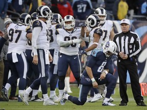 Tennessee Titans quarterback Marcus Mariota (8) gets up off the turf as Los Angeles Rams players celebrate after the Titans' final drive ended and the Rams took possession in the final minutes of the fourth quarter in an NFL football game Sunday, Dec. 24, 2017, in Nashville, Tenn. The Rams won 27-23.