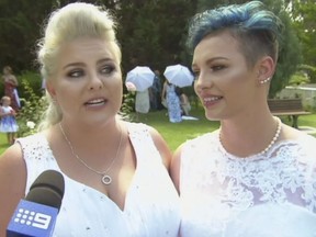 In this image made from video, newlywed couple, Amy Laker, left, and Lauren Price are interviewed during their ceremony in Sydney, Saturday, Dec. 16, 2017.  Two female couples tied the knot in Australia's first same-sex weddings under new legislation allowing gay marriages.  January 9 had been expected to be the first possible date for same-sex weddings due to a four-week waiting period since the landmark law was passed. But the two couples were married in Sydney and Melbourne on Saturday after being granted permission to waive the notice period. Amy Laker, 29, and Lauren Price, 31, exchanged vows in Sydney because their families had to travel from Wales in the U.K. to attend what was to have been their commitment ceremony. (Channel 9 via AP)