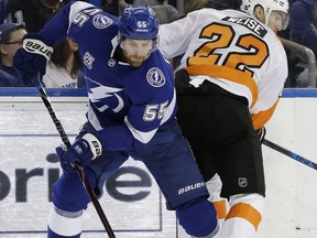 Tampa Bay Lightning defenseman Braydon Coburn (55) strips the puck from Philadelphia Flyers right wing Dale Weise (22) during the first period of an NHL hockey game Friday, Dec. 29, 2017, in Tampa, Fla.