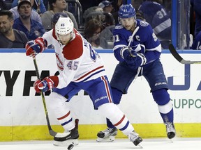 Montreal Canadiens defenseman Joe Morrow (45) strips the puck from Tampa Bay Lightning center Steven Stamkos (91) during the second period of an NHL hockey game Thursday, Dec. 28, 2017, in Tampa, Fla.