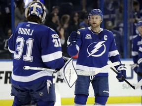Tampa Bay Lightning center Steven Stamkos (91) celebrates with goalie Peter Budaj (31) after the Lightning defeated the Colorado Avalanche 5-2 during an NHL hockey game Thursday, Dec. 7, 2017, in Tampa, Fla.