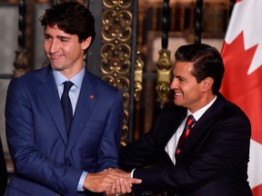 Canada's Prime Minister Justin Trudeau, left, and Mexican President Enrique Pena Nieto shake hands at the presidential palace in Mexico City in October. Canada should decouple itself from Mexico in NAFTA talks, argues Diane Francis.