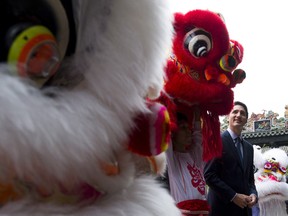 Prime Minister Justin Trudeau stands with lion dancers after watching them perform as he is given a tour of the Chen Clan Academy in Guangzhou, China on Thursday, Dec. 7, 2017.