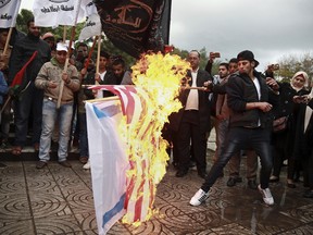 Palestinian demonstrators burn representations of Israeli and American flags during a protest against the possible U.S. decision to recognize Jerusalem as Israel's capital, in Gaza City, Wednesday, Dec. 6, 2017.