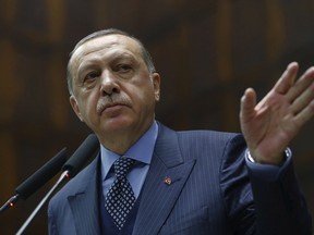 Turkey's President Recep Tayyip Erdogan addresses his supporters at the parliament in Ankara, Turkey, Tuesday, Nov. 28. 2017.
