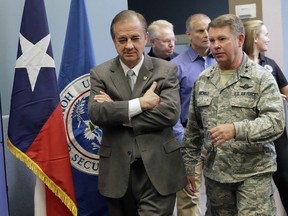 In this Sept. 14, 2017 photo, Commissioner John Sharp walks with Maj. Gen. John F. Nichols, right, following a briefing on Hurricane Harvey recovery efforts at the new FEMA Joint Field Office, in Austin, Texas. Sharp, the recovery czar over Texas' rebuild after Harvey, says his new job is "future-proofing" for the next disaster. How is Texas spending billions in federal aid in response to Harvey, among the costliest U.S. storms on record? State records do not distinguish storm-related expenses, making fund tracking and accountability all but impossible. Disaster recovery experts say the lack of transparency could hinder coordination, encourage fraud and squander an opportunity to not only rebuild, but mitigate the risks of the next monster storm.