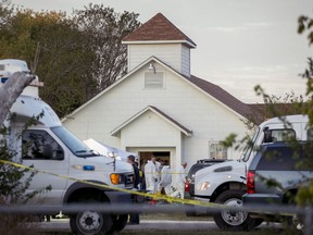 FILE - In this Nov. 5, 2017, file photo, investigators work at the scene of a deadly shooting at the First Baptist Church in Sutherland Springs, Texas. New York City, San Francisco and Philadelphia filed a federal lawsuit Tuesday, Dec. 26, against the Defense Department, saying many service members who are disqualified from gun ownership weren't reported to the national background check system. A Defense Department failure allowed a disgraced former Air Force member to buy a high-powered rifle and shoot 26 people to death at the church.