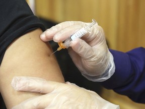 FILE - In this Friday, Sept. 22, 2017 file photo, a flu vaccine injection is administered at the Brownsville Events Center by a pharmacist in Brownsville, Texas. According to data released by the Centers for Disease Control and Prevention on Friday, Dec. 8, 2017, this year's flu season is off to a quick start and so far it seems to be dominated by a nasty bug.
