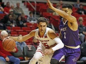 Texas Tech's Davide Moretti (25) drives the ball around Abilene Christian's Tevin Foster (3) during the first half of an NCAA college basketball game Friday, Dec. 22, 2017, in Lubbock, Texas.