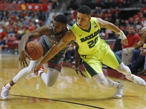 Texas Tech's Niem Stevenson (10) and Baylor's Manu Lecomte (20) try to grab the loose ball during the first half of an NCAA college basketball game Friday, Dec. 29, 2017, in Lubbock, Texas.