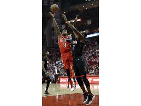 New Orleans Pelicans' Rajon Rondo (9) shoots as Houston Rockets' Luc Mbah a Moute (12) defends during the first quarter of an NBA basketball game Monday, Dec. 11, 2017, in Houston.