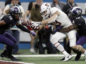 Stanford wide receiver J.J. Arcega-Whiteside (19) stretches out with a pass in front of TCU cornerback Jeff Gladney (12) for a touchdown during the first half of the Alamo Bowl NCAA college football game, Thursday, Dec. 28, 2017, in San Antonio.