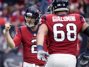 Houston Texans quarterback T.J. Yates (2) celebrates with teammate Breno Giacomini (68) after he threw a touchdown pass to receiver DeAndre Hopkins (10) during the first half of an NFL football game against the San Francisco 49ers, Sunday, Dec. 10, 2017, in Houston.