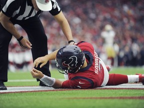 Houston Texans quarterback Tom Savage (3) is checked by a referee after he was hit during the first half of an NFL football game against the San Francisco 49ers, Sunday, Dec. 10, 2017, in Houston. Savage left the game.