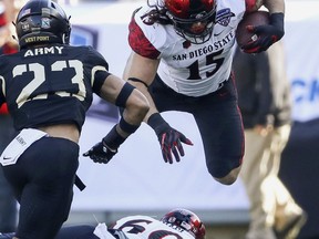 San Diego State fullback Nick Bawden (15) gets tripped up against Army during the first half of the Armed Forces Bowl in an NCAA college football game in Fort Worth, Texas, S