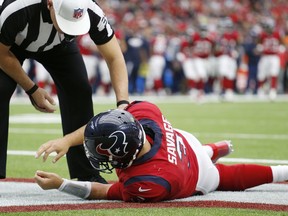 Referee John Hussey checks on Houston Texans quarterback Tom Savage following a hard hit during the second quarter of an NFL football game against the San Francisco 49ers on Sunday, Dec. 10, 2017 at NRG Stadium in Houston. The 49ers defeated the Texans 26-16.