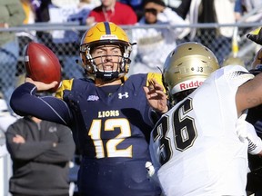 Texas A&M-Commerce quarterback Luis Perez (12) throws under pressure from Harding defender Shedrick Robinson during an NCAA Division II college football game in Commerce, Texas, Saturday, Dec. 9, 2017.  Texas A&M-Commerce quarterback Luis Perez and Gannon running back Marc Jones highlight The Associated Press Division II All-America team. The team was selected by a panel of sports information directors from around the country. Perez leads D-II in yards passing with 4,390 yards and has thrown 42 touchdowns. The senior has guided Texas A&M-Commerce to the Division II national championship game, where it will play West Florida on Saturday in Kansas City, Kansas. (John Markon/The Herald-Banner via AP)