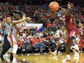 Houston's Galen Robinson Jr. (25) inbounds the ball as Arkansas' Adrio Baily (2) defends during an NCAA college basketball game, Saturday, Dec. 2, 2017 in Houston.
