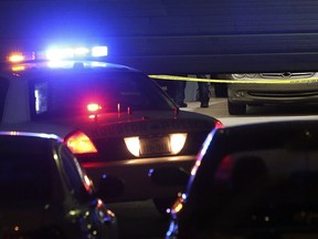 Houston Police Department officers investigate a double murder and suicide scene at 14300 South Post Oak Road on Friday, Dec. 29, 2017, in Houston. Police say a man walked into a Houston auto shop where he used to work and fatally shot two people before going outside and killing himself. The man, whose name wasn't immediately released, entered Bemer Plus about 4 p.m. Friday. The shop specializes in used BMW sales and repairs.