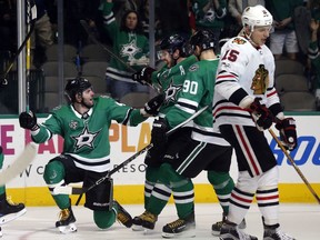 Dallas Stars right wing Alexander Radulov (47) celebrates a goal against the Chicago Blackhawks with center Tyler Seguin (91) and center Jason Spezza (90) as Chicago Blackhawks center Artem Anisimov (15) skates away, during the first period of an NHL hockey game, Saturday, Dec. 2, 2017, in Dallas.