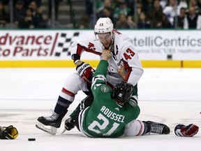 Washington Capitals right wing Tom Wilson (43) and Dallas Stars left wing Antoine Roussel (21) fight during the first period of an NHL hockey game  in Dallas, Tuesday, Dec. 19, 2017.