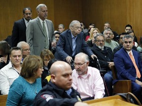 Former priest John Feit, center, enters the courtroom for closing arguments in his murder trial, Thursday, Dec. 7, 2017, at the Hidalgo County Courthouse in Edinburg, Texas. Feit is accused of suffocating Irene Garza in April 1960, after she went to confession at Sacred Heart Catholic Church in McAllen.